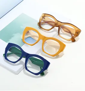 Detailed view of thick cat-eye frames in amber brown, yellow, and blue colors