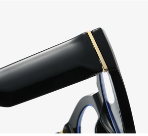 Macro detail of the polished black cat-eye glasses frame with premium gold hinge inlay