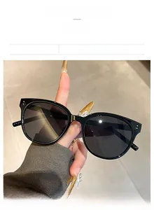 Detail of vintage round sunglasses featuring black frames and metal rivet accents
