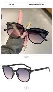 Detail view of retro round sunglasses with black frames and gray pink gradient lenses