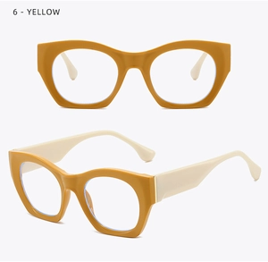 Detail of vintage cat-eye glasses frame in mustard yellow with white temples