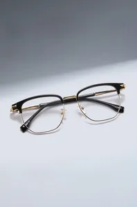 Close-up of TR90 semi-rimless optical glasses showing black and gold browline frame detail