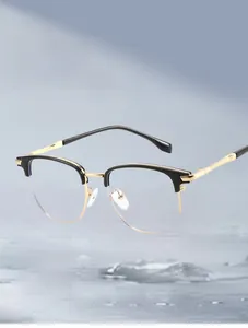 Detail view of TR90 half-frame eyeglasses with black browline and golden metal temples