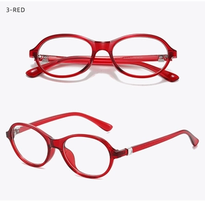 Detail of red translucent TR90 oval glasses with silver heart temple hinges and dual views