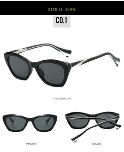 Detail view of cat eye sunglasses with silver wave metal accents and gray lenses