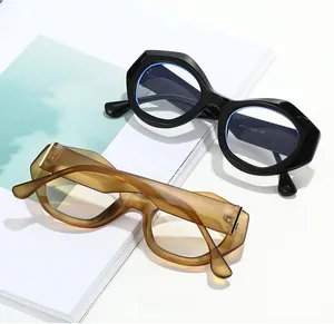 Detailed top view of thick oval eyeglass frames in glossy black and matte amber acetate