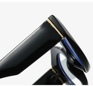 Close-up of golden metal hinge and glossy black frame on stylish sunglasses