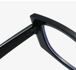 Close-up of durable metal hinges and screw details on glossy black square frame glasses