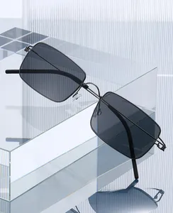 Close-up of minimalist screwless square sunglasses on a clear acrylic geometric stand
