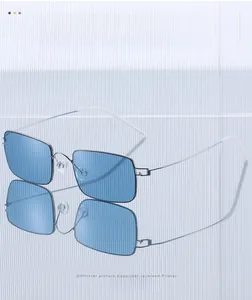 Detail view of square blue sunglasses with silver metal frame and white temple tips