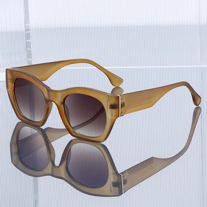 Retro cat-eye sunglasses with translucent amber frames and gradient brown lenses