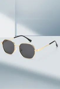 Detailed view of fashionable octagonal gold metal frame sunglasses with dark polarized lenses