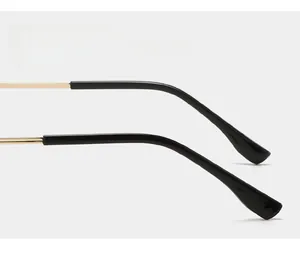 Detail of curved non-slip sunglasses temples in gold metal and black tips