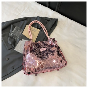 Detailed close-up of pink sequin shoulder bag with woven handle on a stylish background