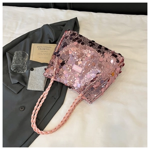 Detail of pink sequin tote bag with woven shoulder strap and round sparkling sequins
