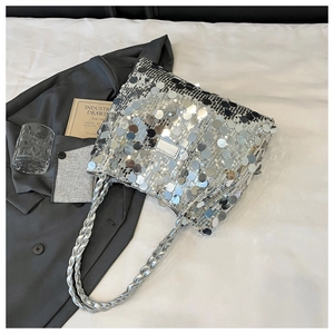 Detail of silver sequin tote bag showing glossy round sequins and woven chain strap