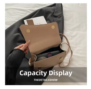 Interior view showing the storage capacity of a beige leather shoulder bag with essentials