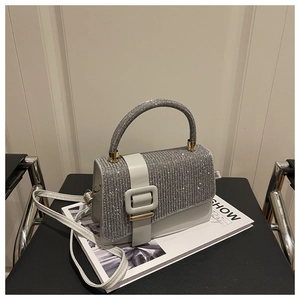 Vue détaillée du sac à main en strass argentés avec boucle décorative et bandoulière en cuir