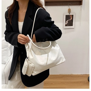 Vue détaillée du sac polochon blanc en tissu Oxford et de sa petite pochette assortie