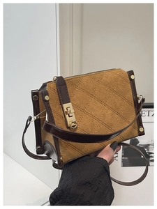 Detail of retro crossbody bag with denim texture, diamond stitching and brown leather trim