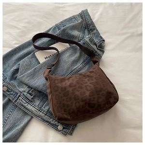 Detail of leopard print hobo bag with adjustable wide strap and vintage fabric texture