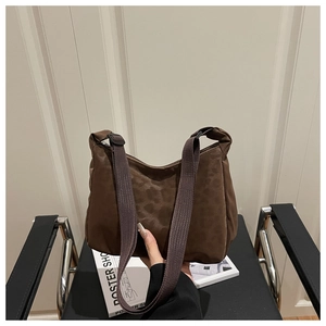 Detail of dark brown leopard nylon hobo bag with a wide strap held by hand