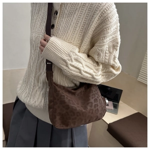 Side view of leopard print crossbody crescent bag with adjustable shoulder strap