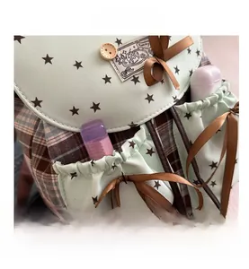Detail of vintage star pattern flap and bow on plaid academic style backpack