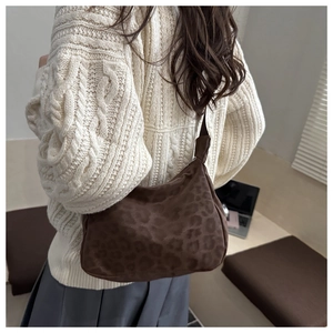 Detailed texture of brown leopard print shoulder bag with soft fuzzy fabric finish