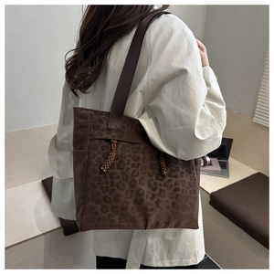 Detail of leopard print tote bag with woven drawstring and durable shoulder straps