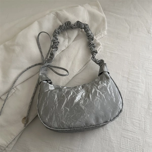 Silver metallic pleated crescent bag with scrunched strap and glossy texture for women