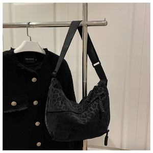 Détail du sac hobo léopard noir avec bandoulière large réglable et fermeture éclair tressée