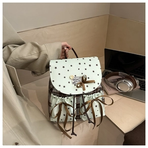 Detail of mint green star pattern and brown plaid backpack with bow decoration