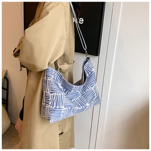 Detailed close-up of the blue and white woven geometric pattern on the hobo tote bag