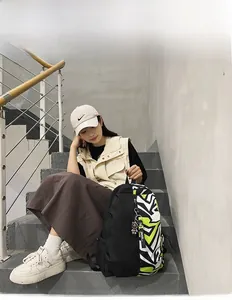 Detail of street style black backpack with green zebra patterns on outdoor stairs