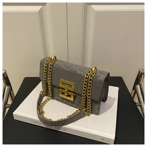 Detail of grey crossbody bag showing leopard print texture and metal chain strap