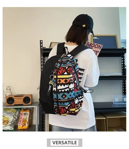 Detail of colorful geometric print canvas backpack with a decorative MASK ribbon hanging