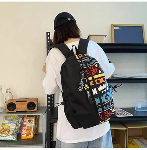 Detailed side view of stylish graffiti backpack with colorful geometric patterns and astronaut charm