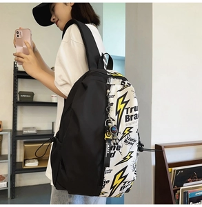 Detail of trendy graffiti backpack with side drawstring and decorative MASK lanyard