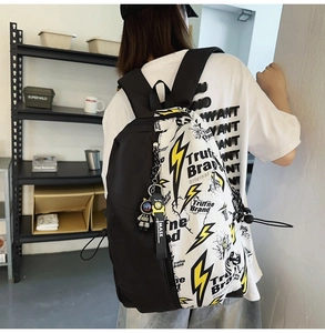 Detail of street style graffiti backpack with astronaut charm and lightning graphic