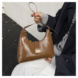 Brown semi-circle hobo bag with glossy leather texture and golden metal buckle detail