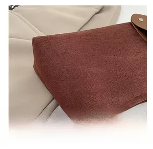 Detail of caramel suede fabric showing fine texture and neat stitching on the tote bag