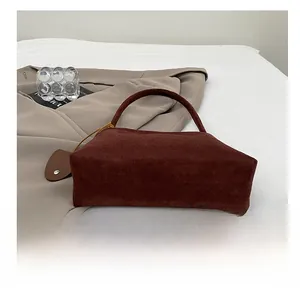 Detail view of the durable wear-resistant bottom on this brown suede hobo shoulder bag