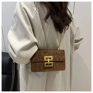 Brown leopard print square bag with gold metal buckle and chain strap on model