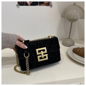 Detail of black leopard print bag with gold interlocking square lock and chain strap