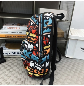 Detailed side view of graffiti backpack featuring side water bottle pocket and metal zippers