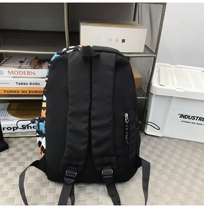 Detail of a black graffiti backpack featuring a side hidden zipper pocket and fabric texture