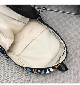 Detail view of the backpack interior showing multiple compartments and colorful panels
