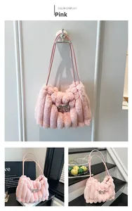 Detailed view of pink fuzzy shoulder bag with stripe texture and silver bow accent