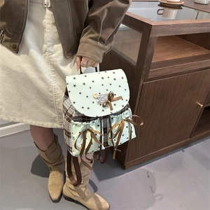 Mint green bow backpack with star print and brown plaid panels in minimalist style